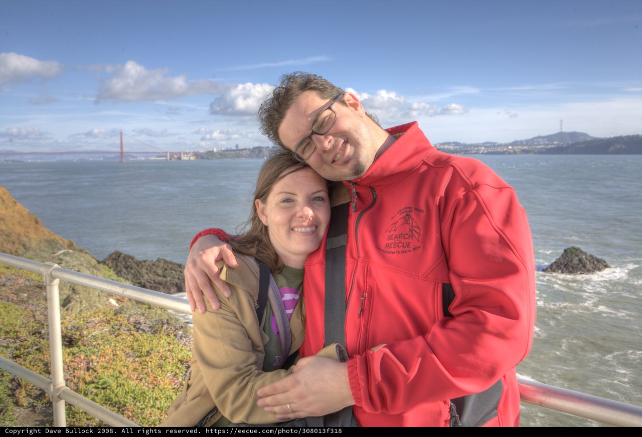 Couple Embracing with Golden Gate Bridge Behind