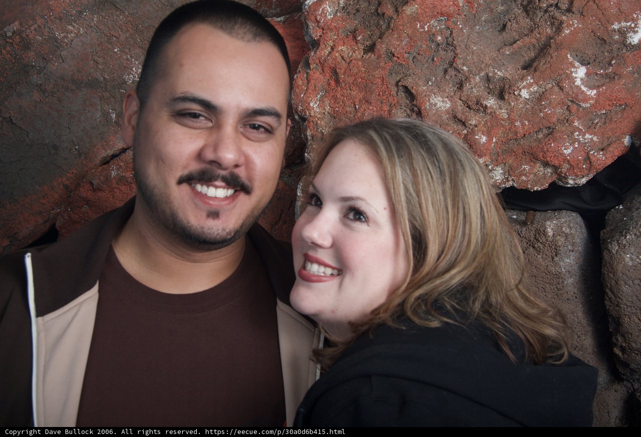 Smiling Couple in Front of Rock Wall