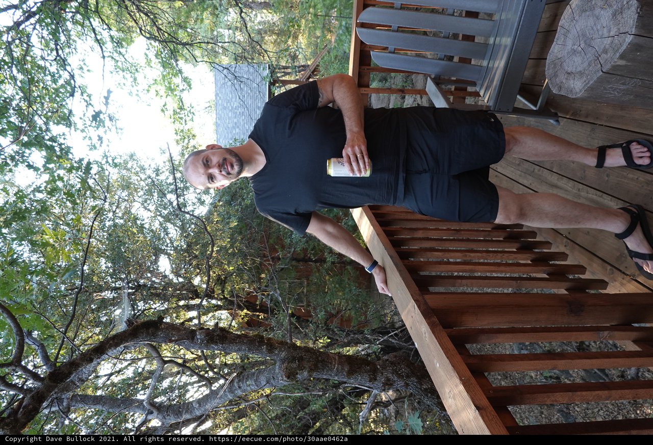 Man Enjoying Morning Coffee on Wooden Deck