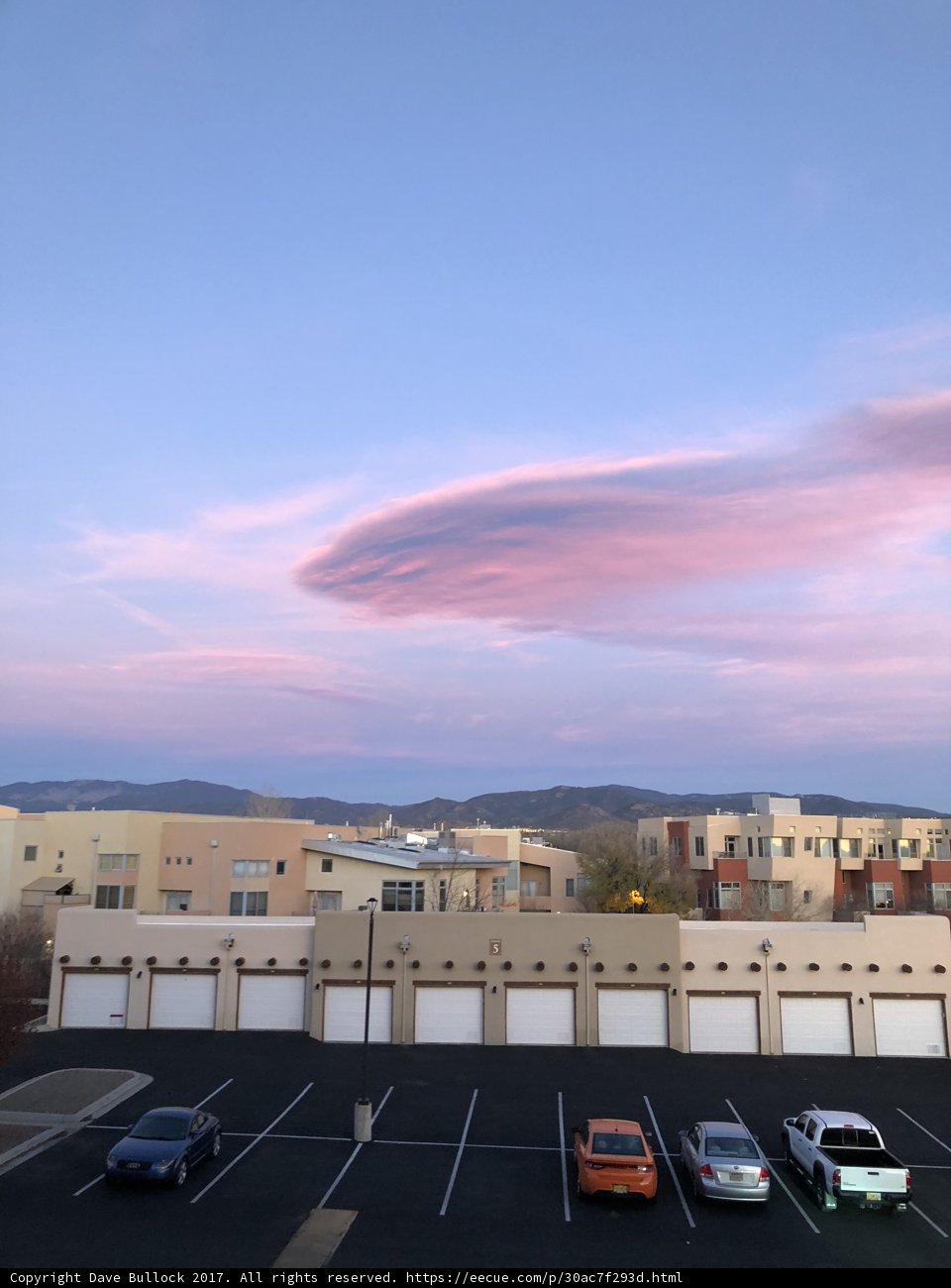 Pink Clouds Above a Busy Parking Lot