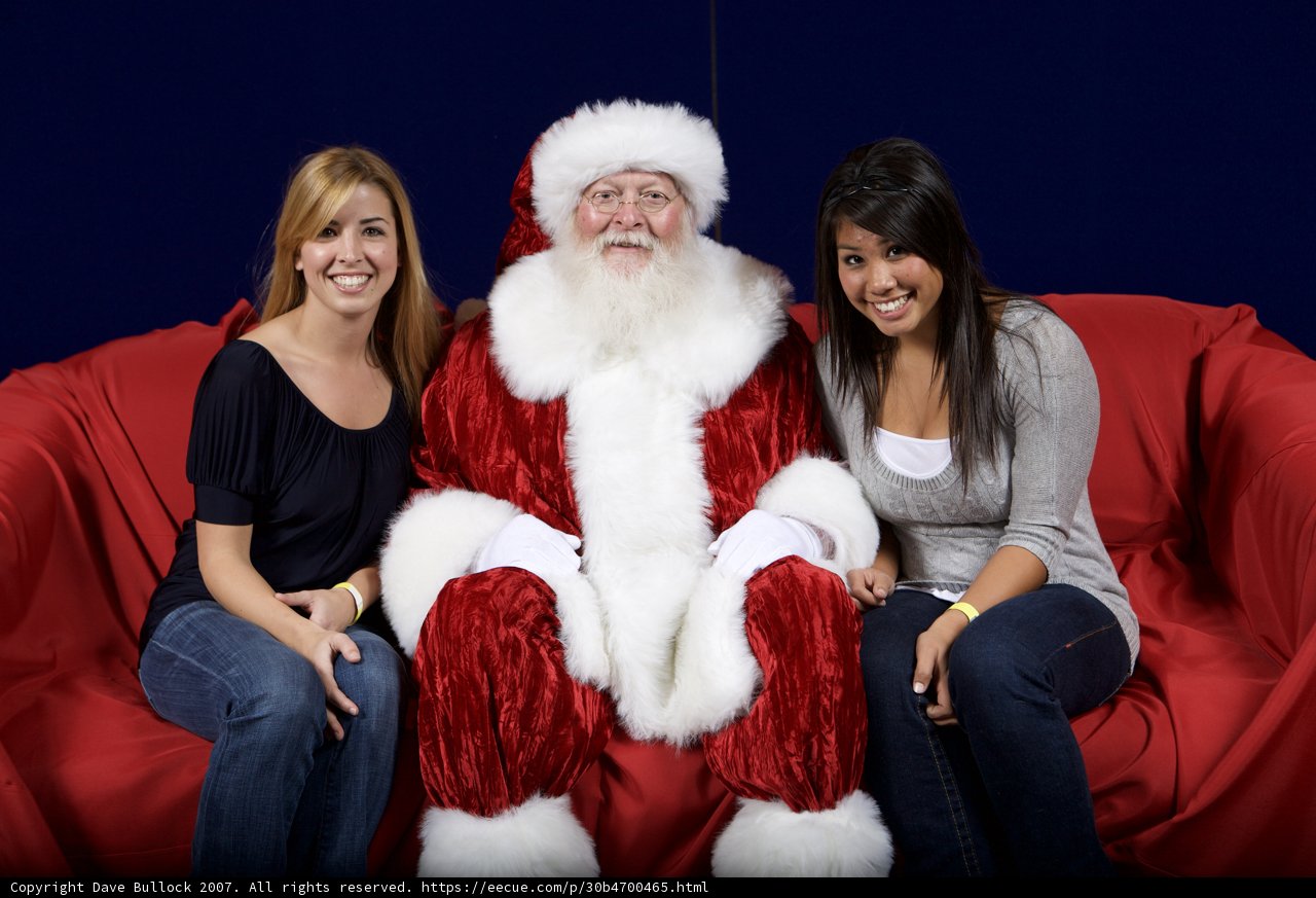 Santa joins the ladies on a red couch