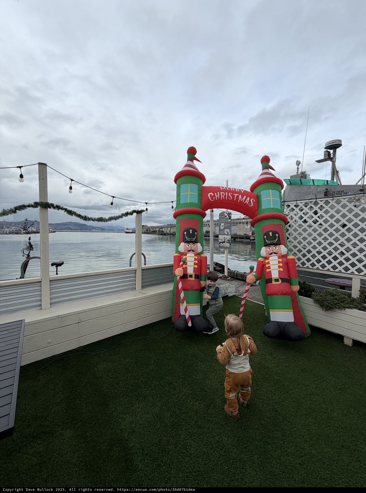 Children Exploring Christmas Nutcracker Inflatables at Waterfront