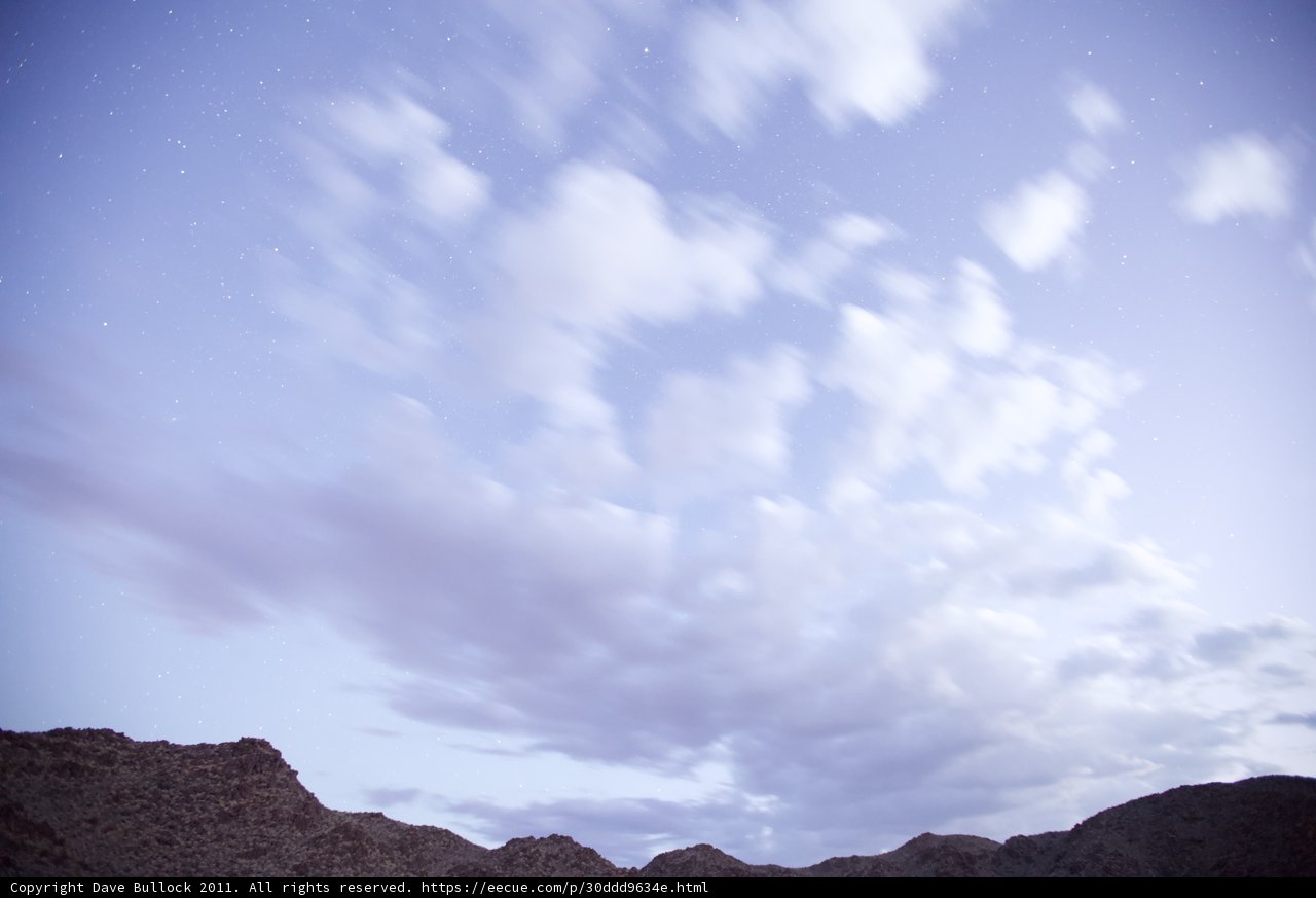 Majestic Mountain Range Beneath A Blush Blue Sky