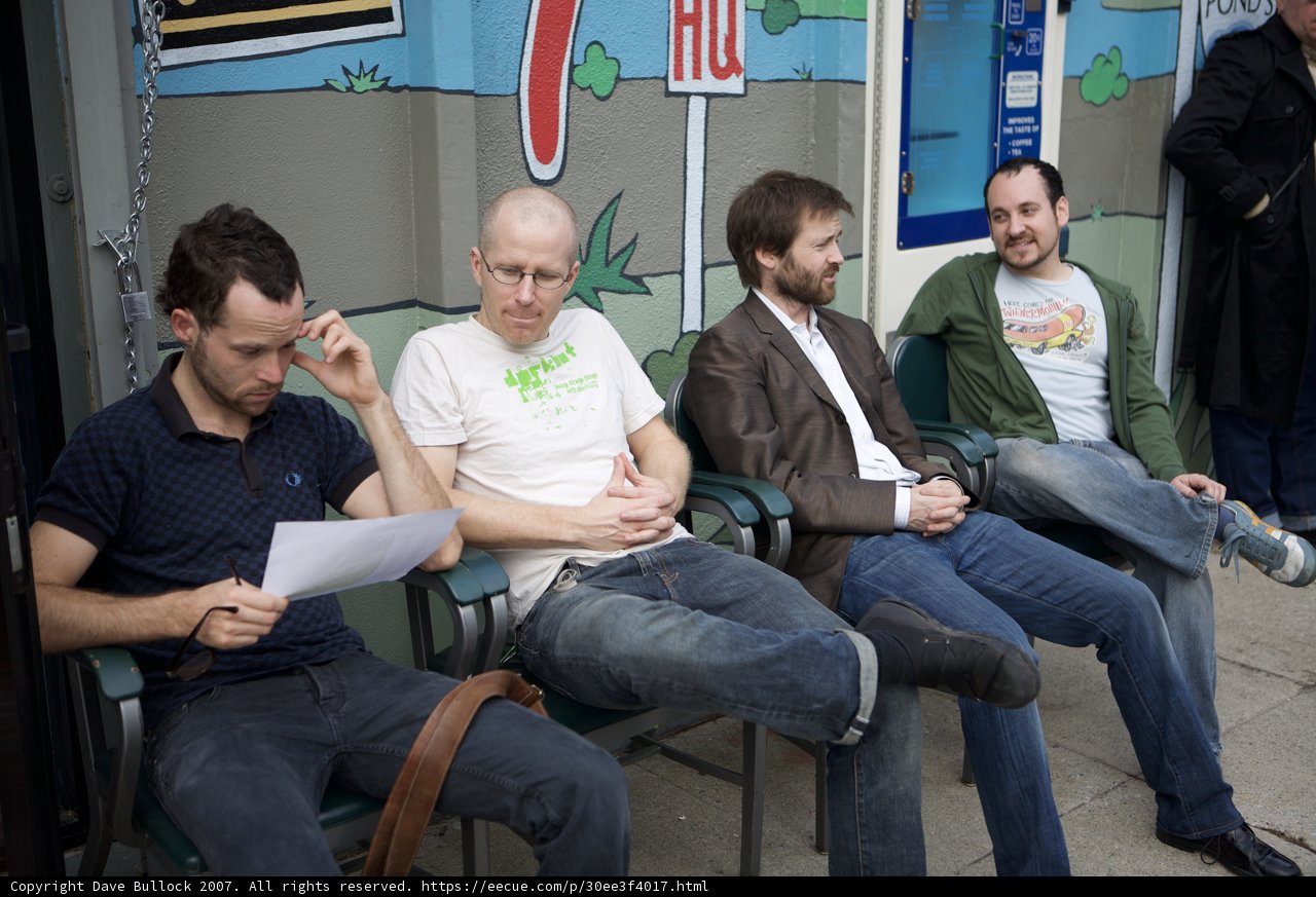 Four Men Waiting Outside
