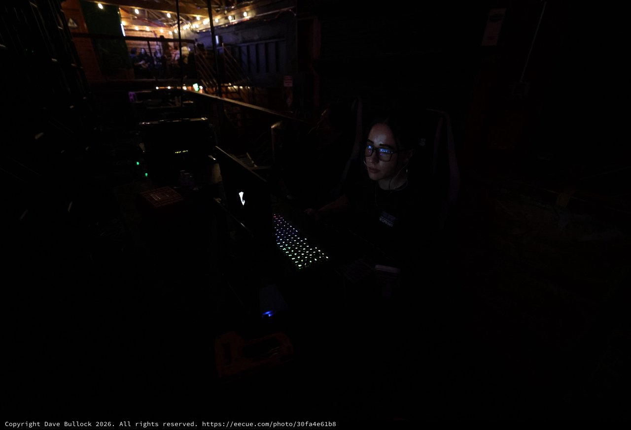 Lighting Technician Working in Darkened Concert Booth