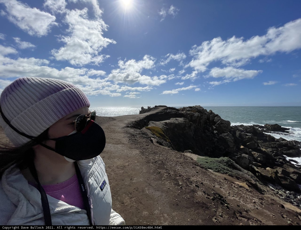 Masked Hiker on the Rocky California Coast