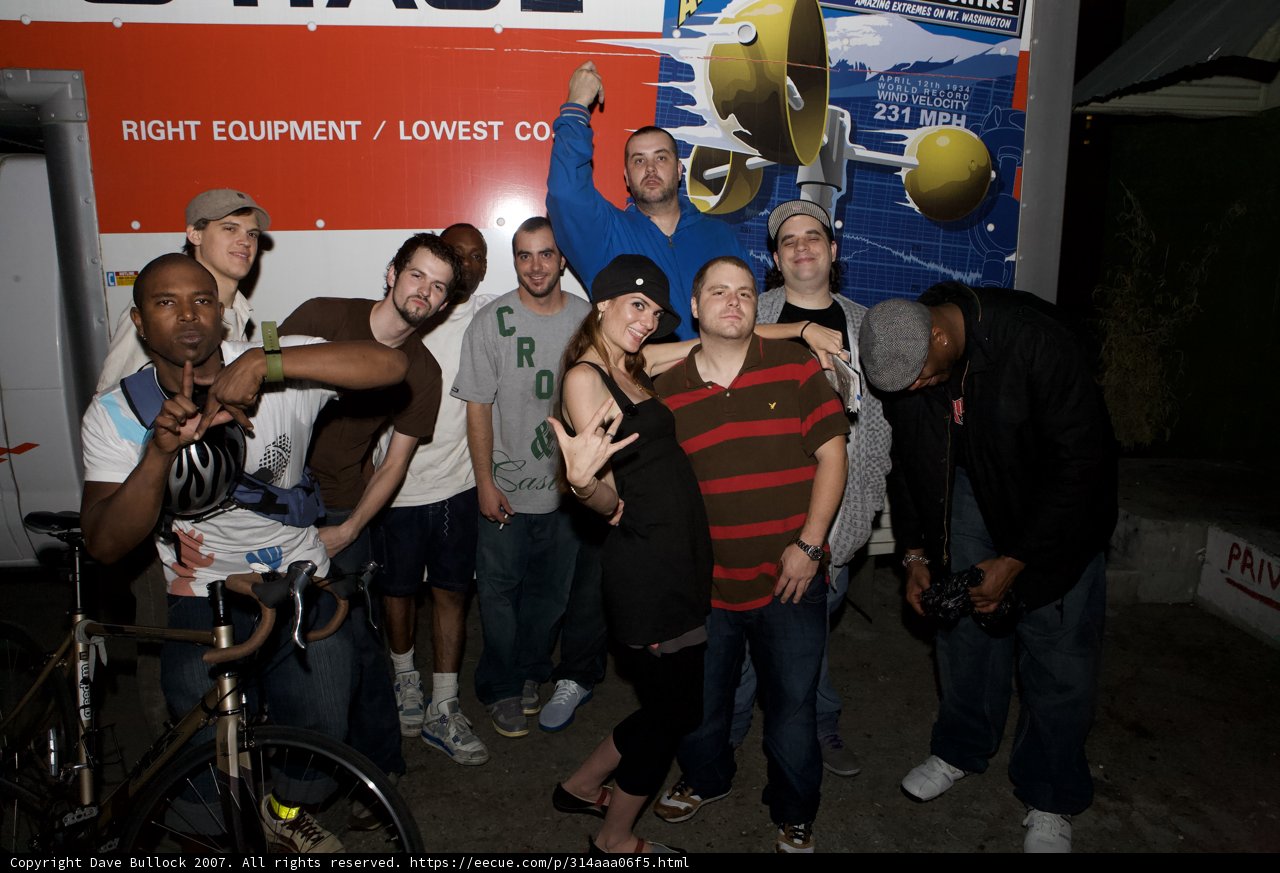 Group of Cycling Enthusiasts in Front of White Van