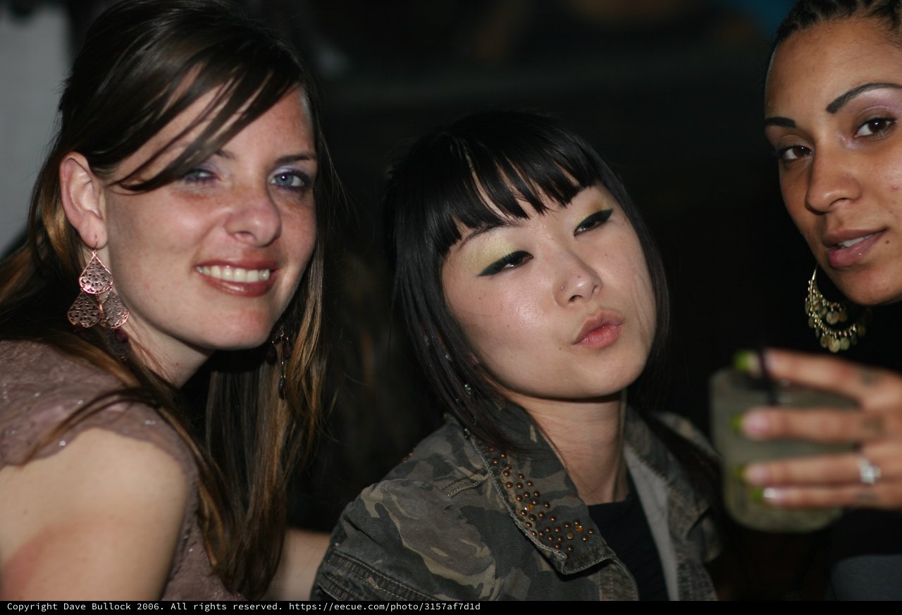 Three Friends Posing at a Nightclub Party Event