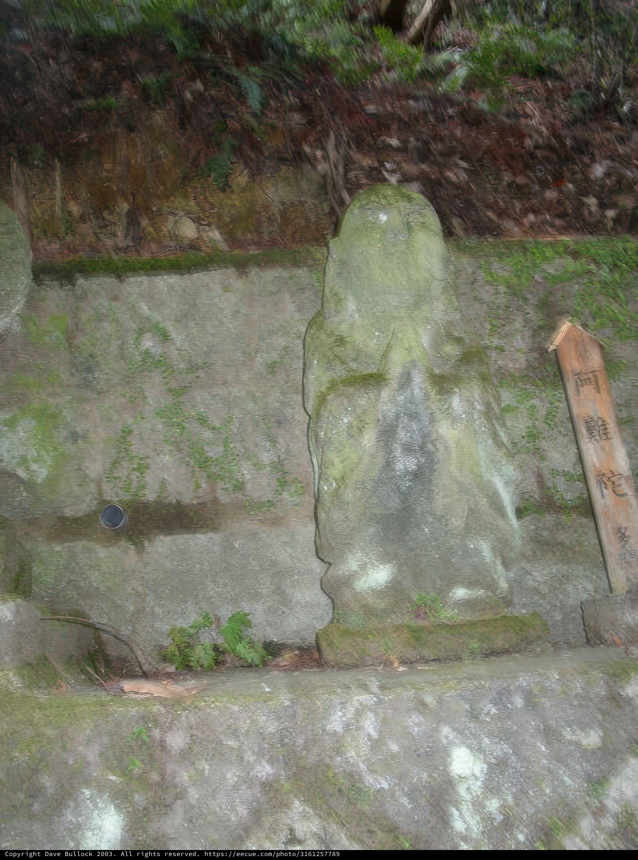 Stone Buddha Statue on Ledge
