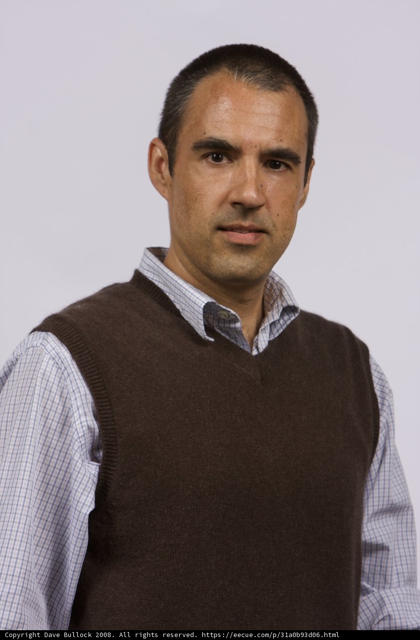 Smiling Man in Sophisticated Sweater Vest