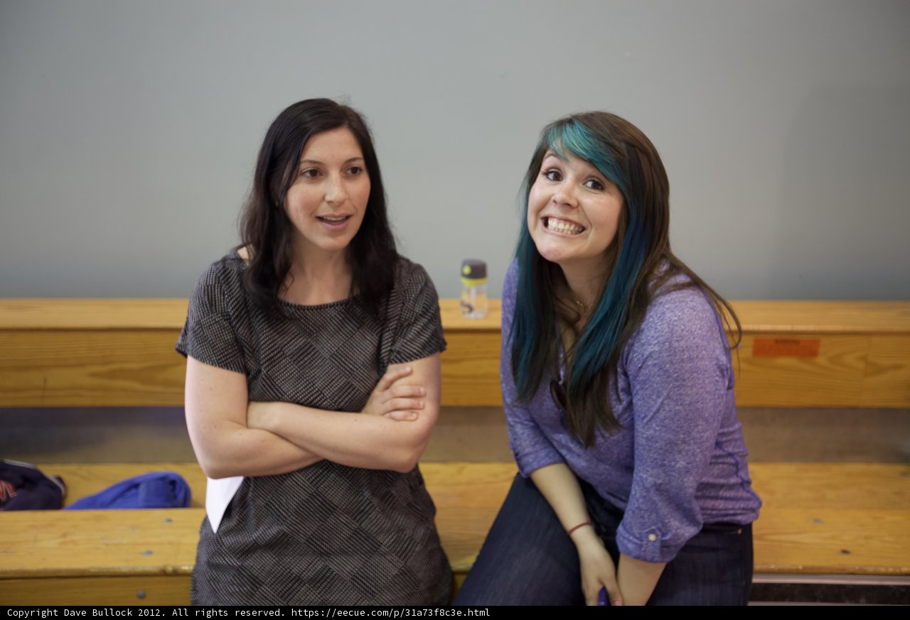 Two Women Enjoy Their Time on a Wooden Bench