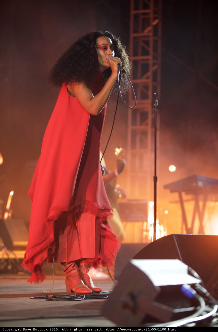 Solange Full Body Red Outfit Saxophonist Arm Raised Scaffolding