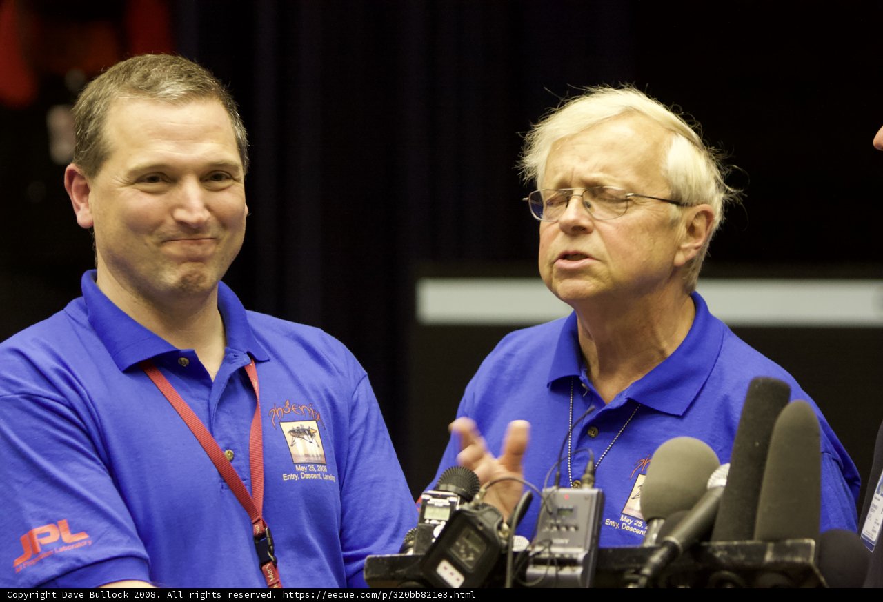 Press Conference with Two Men in Blue Shirts