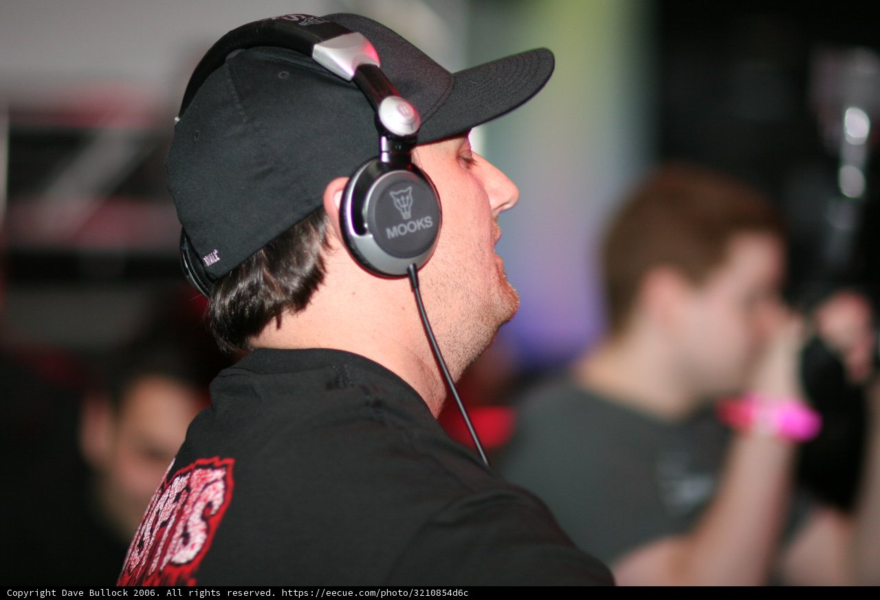 Black Shirted Man Listening to Music
