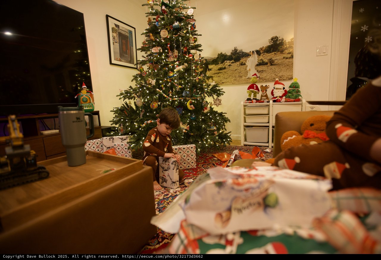 Child Unwrapping Presents on Christmas Morning 2025