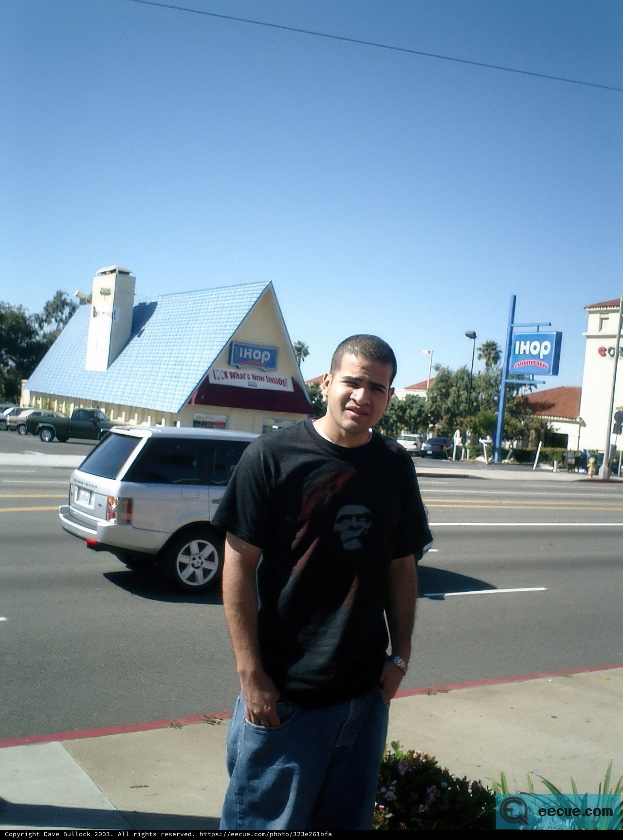 Man on a Street Corner with a Pickup Truck