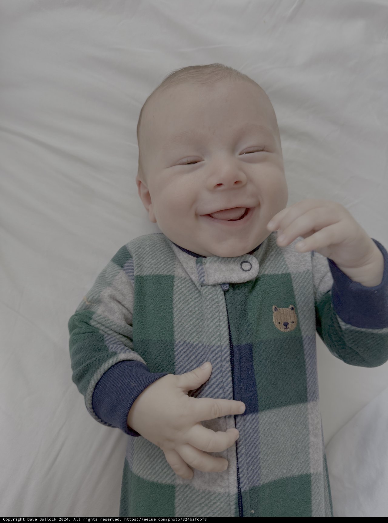 Joyful Baby Smiling in Colorful Sleeper