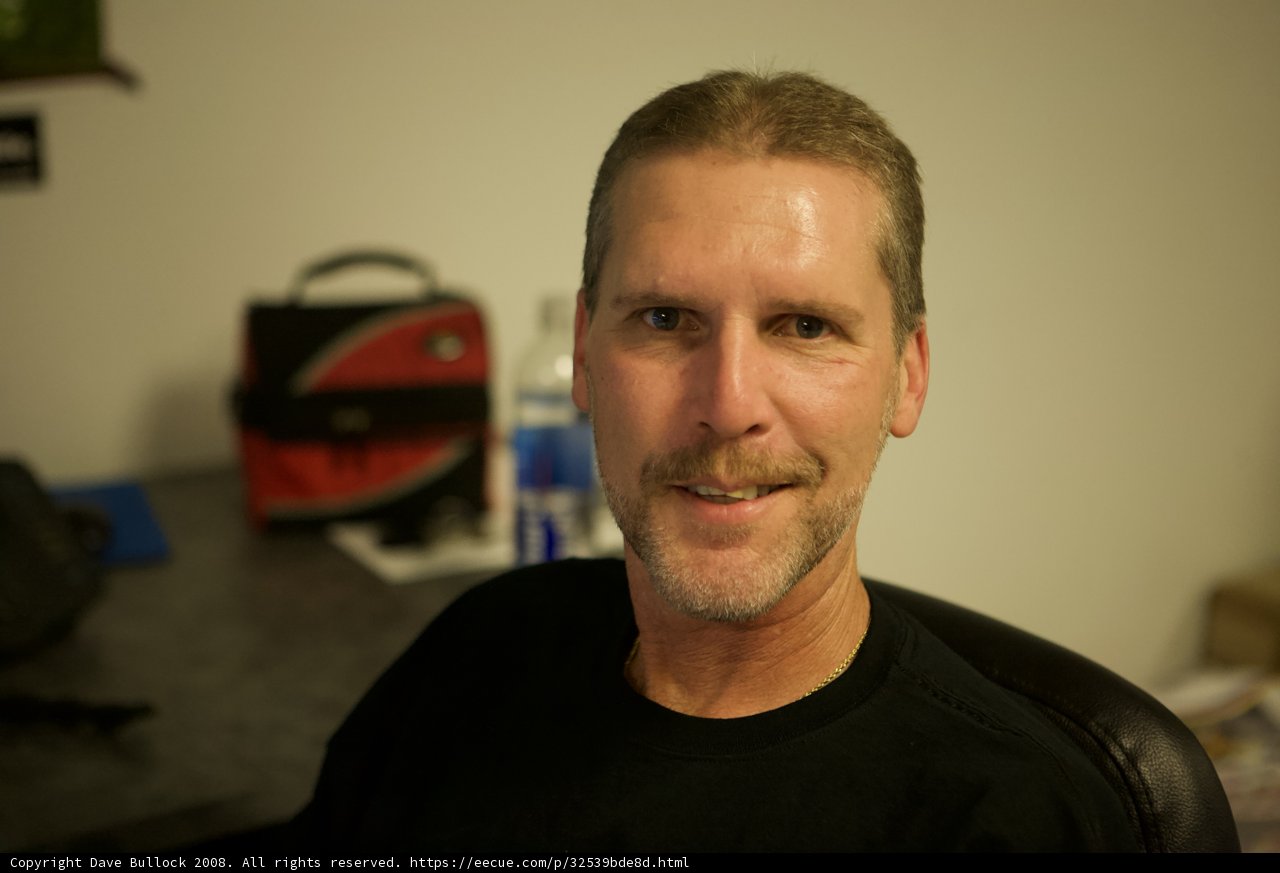 Smiling Mustached Man with Handbag
