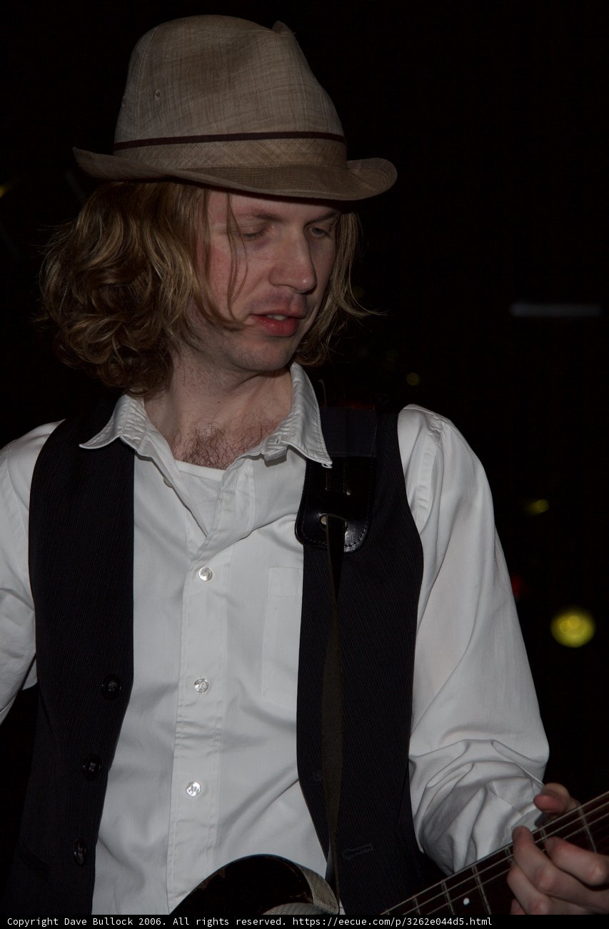 Beck Strums His Guitar in Fedora and Vest