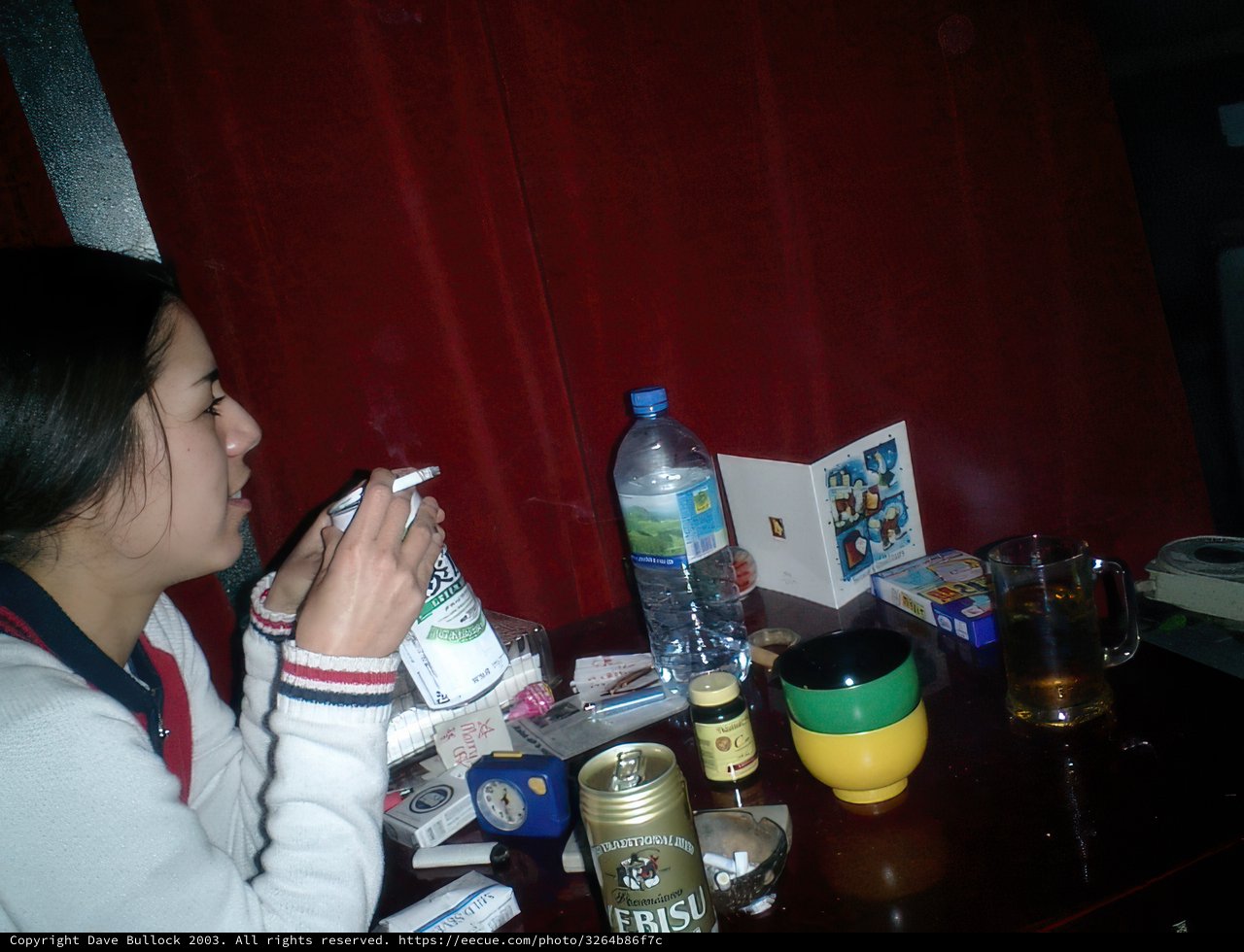 A Woman Enjoying Her Drink and Cigarette at a Tokyo Bar