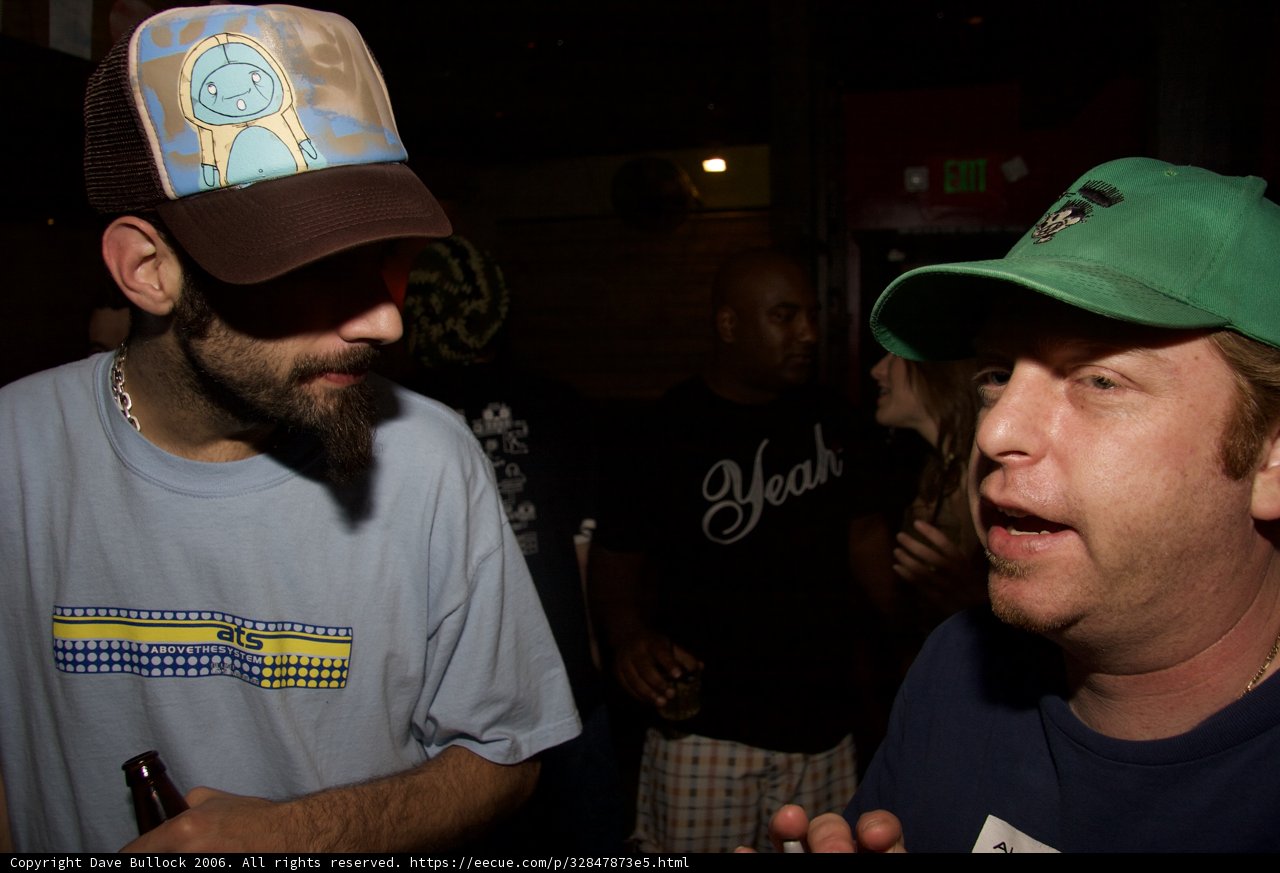 Two Men Enjoying Beer and Conversation at Party