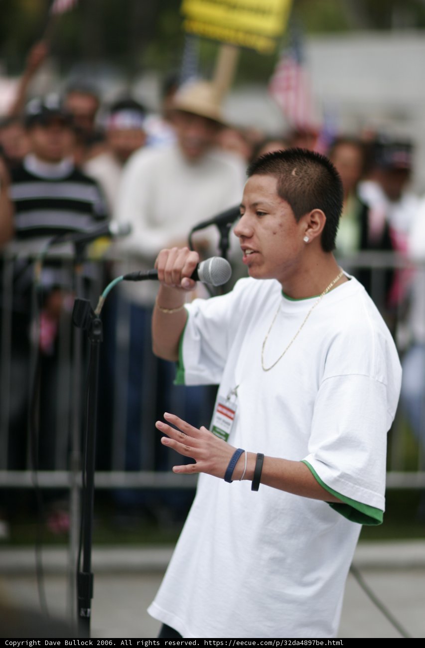 Hugo Ayala addresses the crowds Caption: Hugo Ayala holds a microphone and addresses a sea of faces during the 2006 student protest.