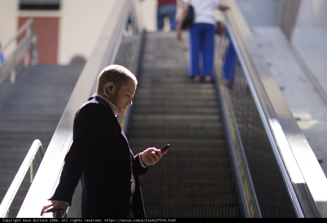 On the Phone at the Escalator