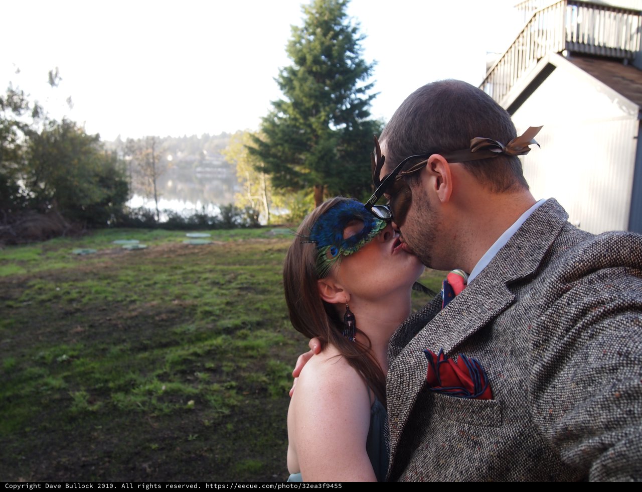 Masquerade Kiss by the Waterfront at Dusk