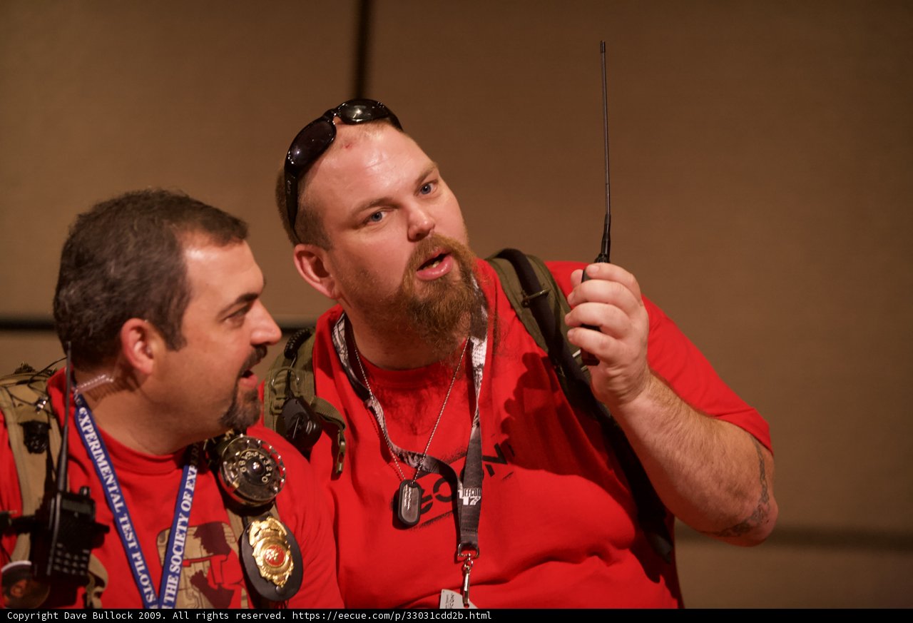 Red Shirted Men Bonding over Technology