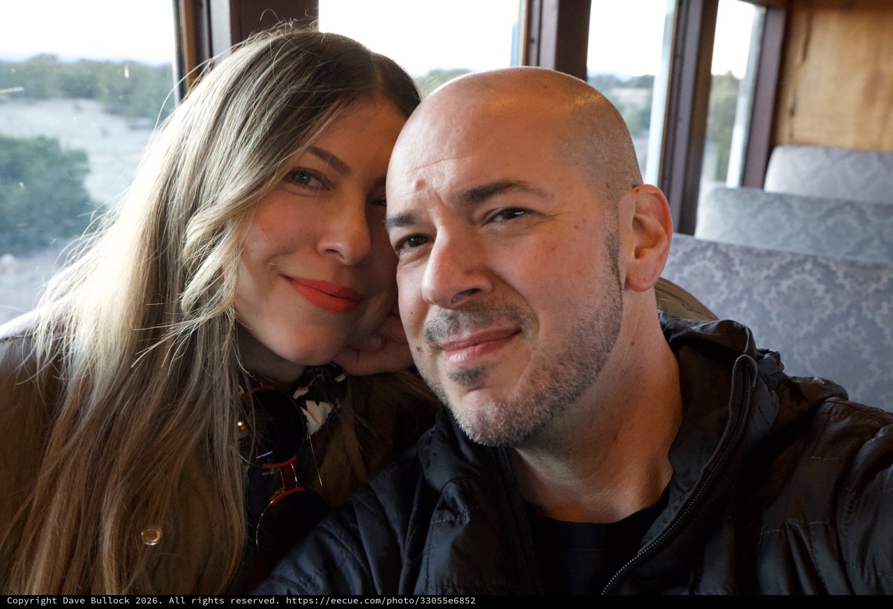 Couple's Romantic Train Journey Through Scenic Landscape
