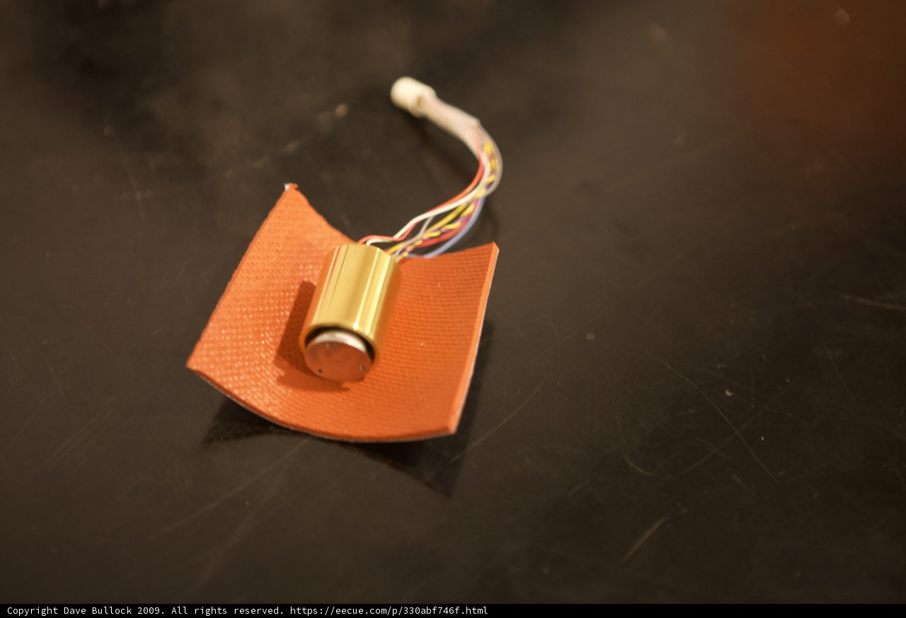 Microscopic View of Orange Material with Wires
