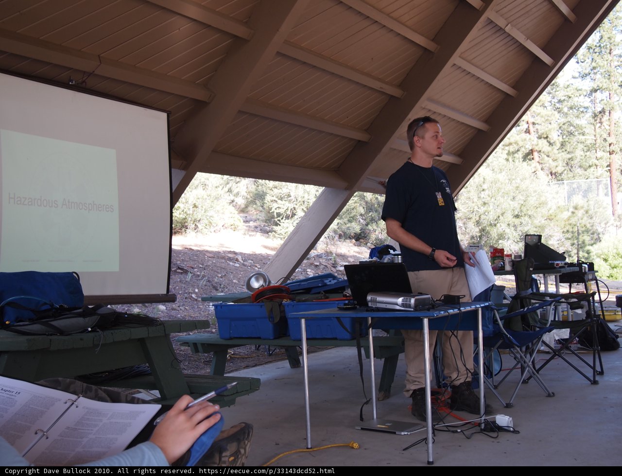 Man Presenting on Laptop in Front of Screen