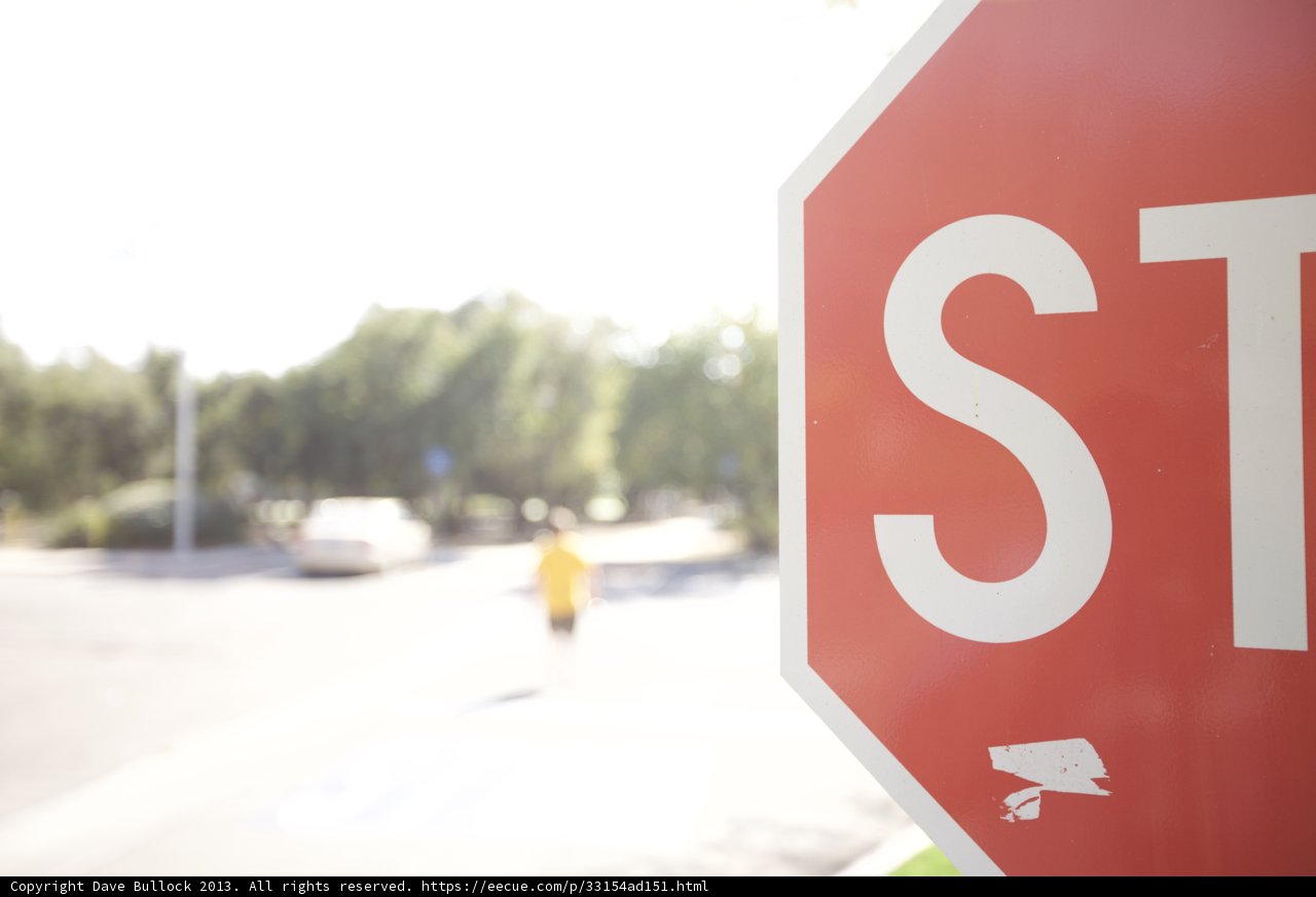 A Stop Sign and a Pedestrian