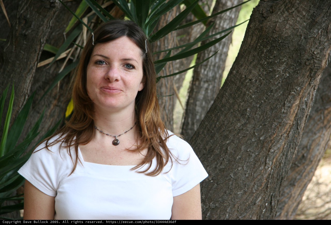 Portrait of Young Woman Among Palm Trees