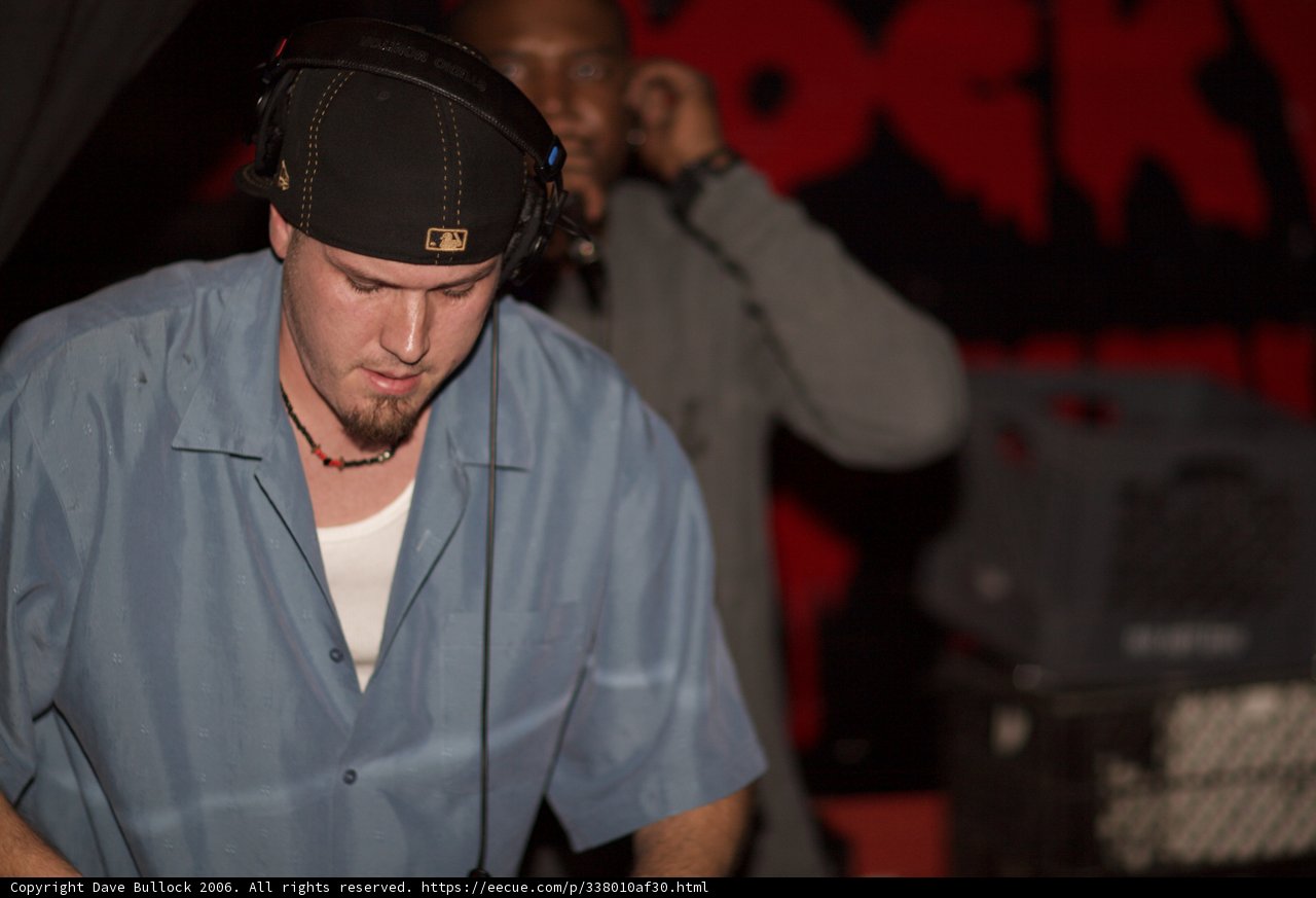Travis B Wearing Blue Shirt and Hat at Concert