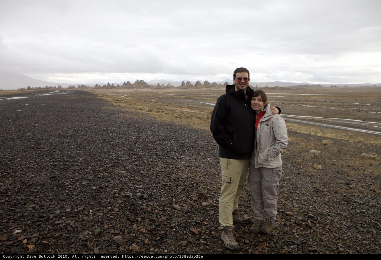 Couple Poses Among Trona Pinnacles Desert Landscape
