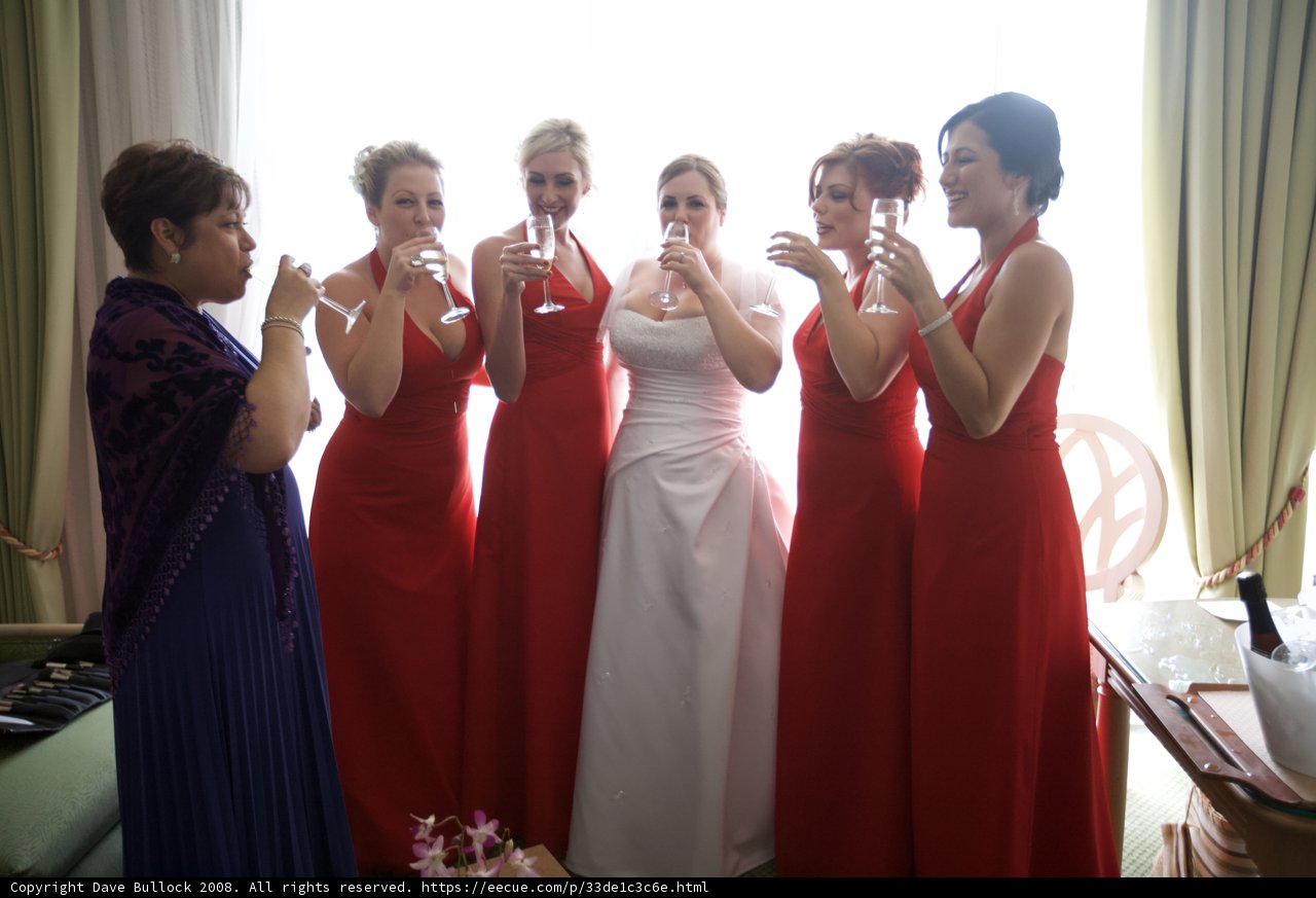 Red-clad bridesmaids raise a toast