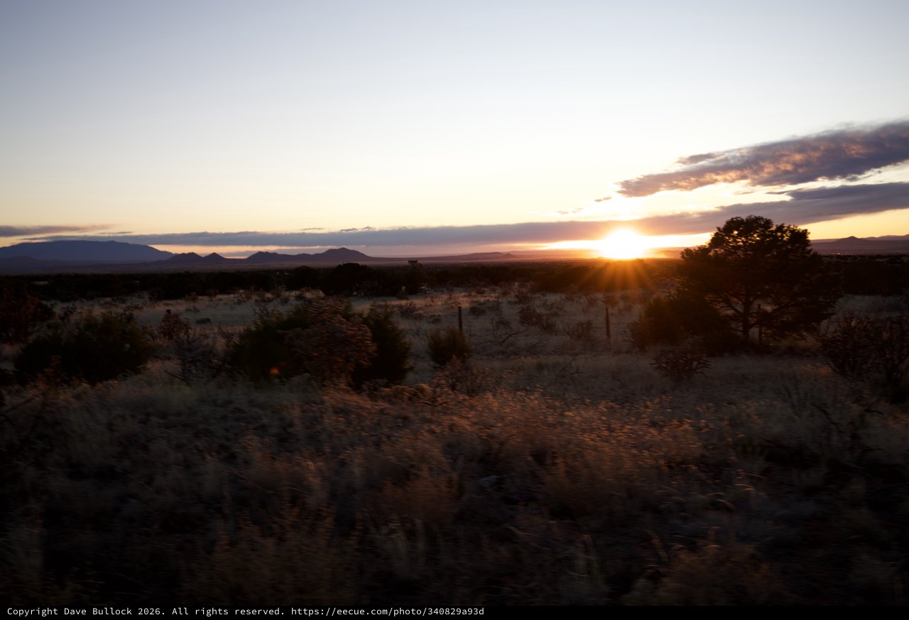 Desert Sunset Over Distant Mountain Range