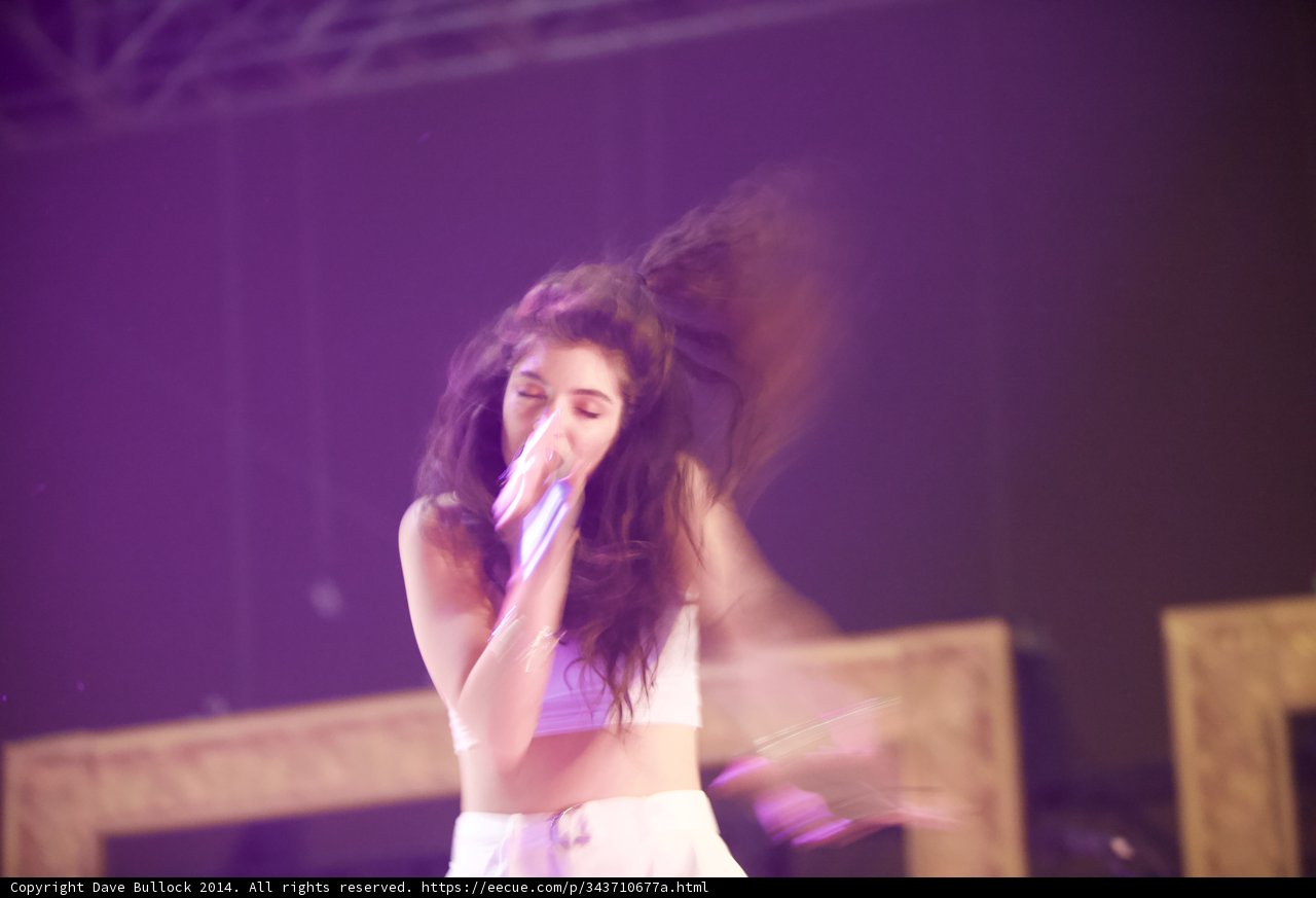Lorde Takes the Stage with Microphone in Hand