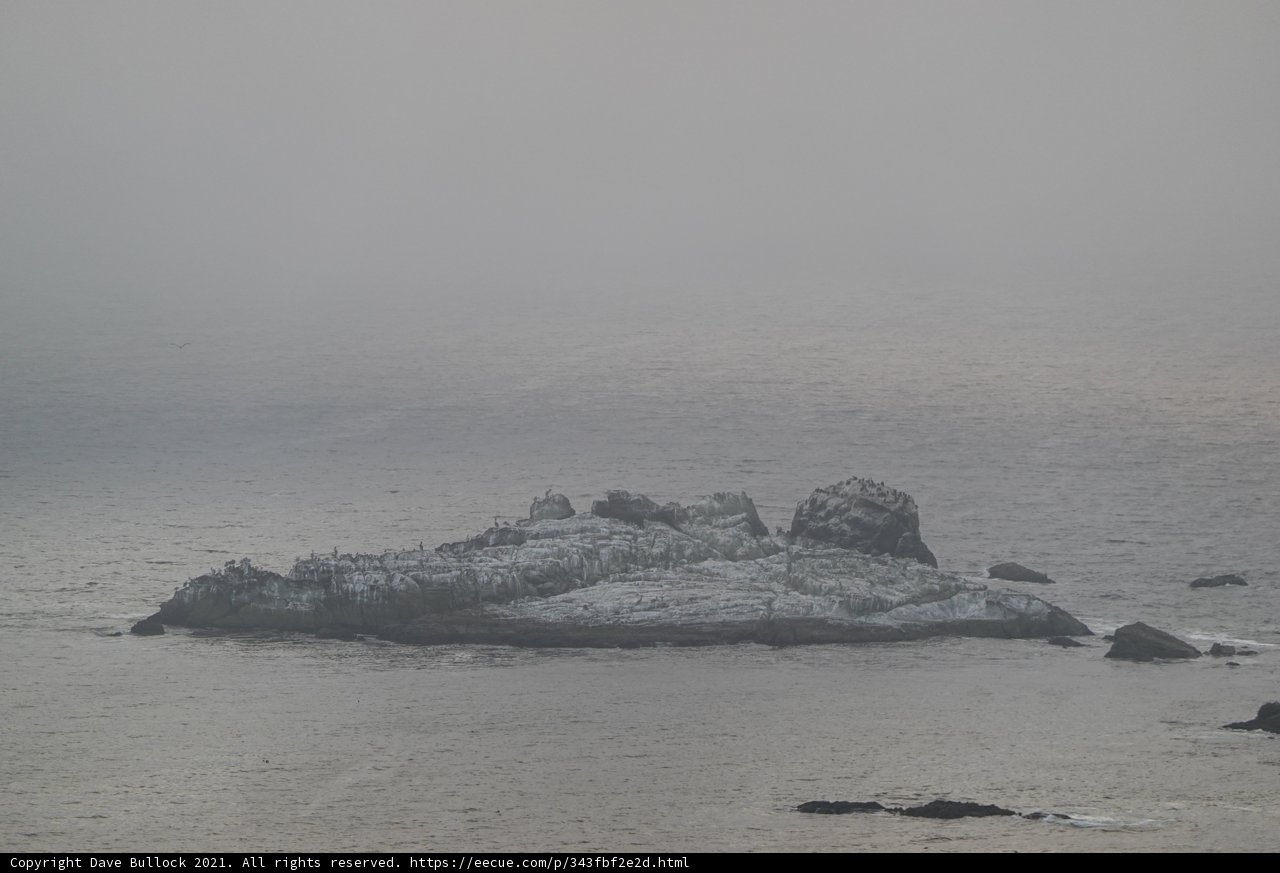 Solitary Rock in the Misty Ocean