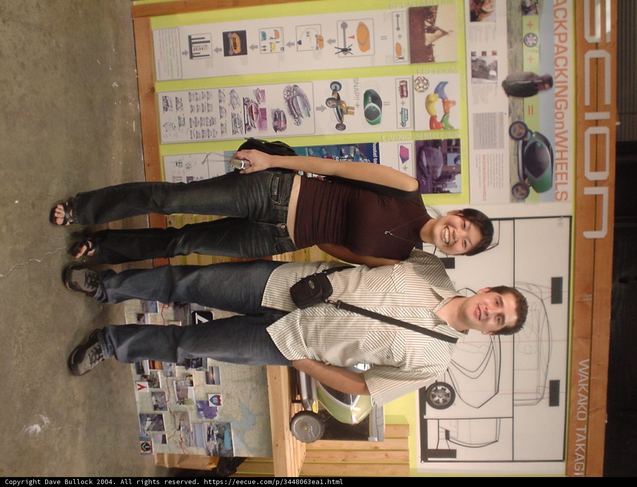 Couple Poses Next to Wooden Sign