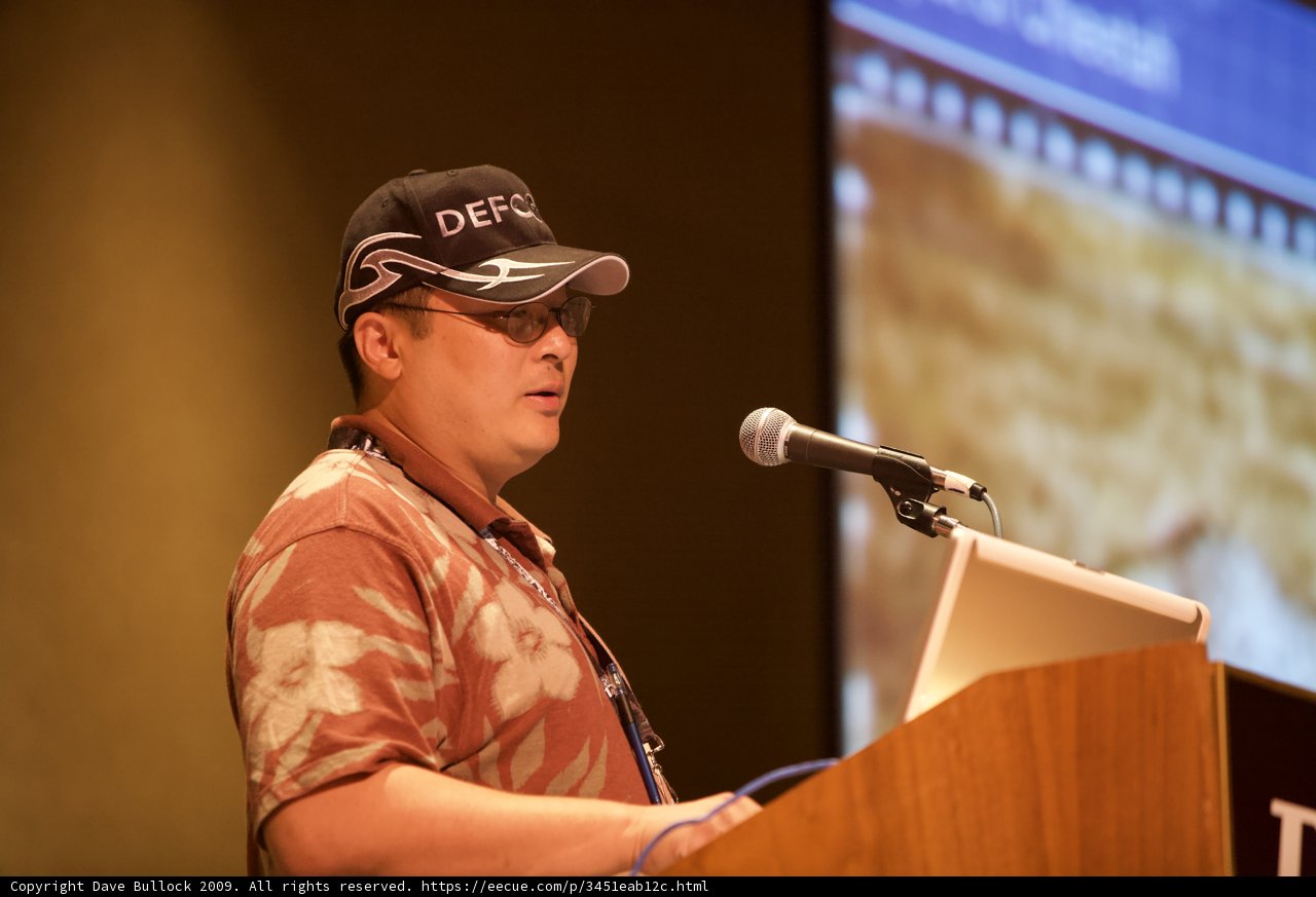 Man with Hat and Glasses Gives Speech