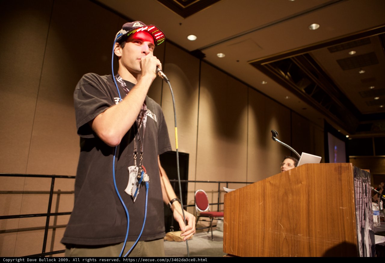 Man with Hat Speaks at Podium