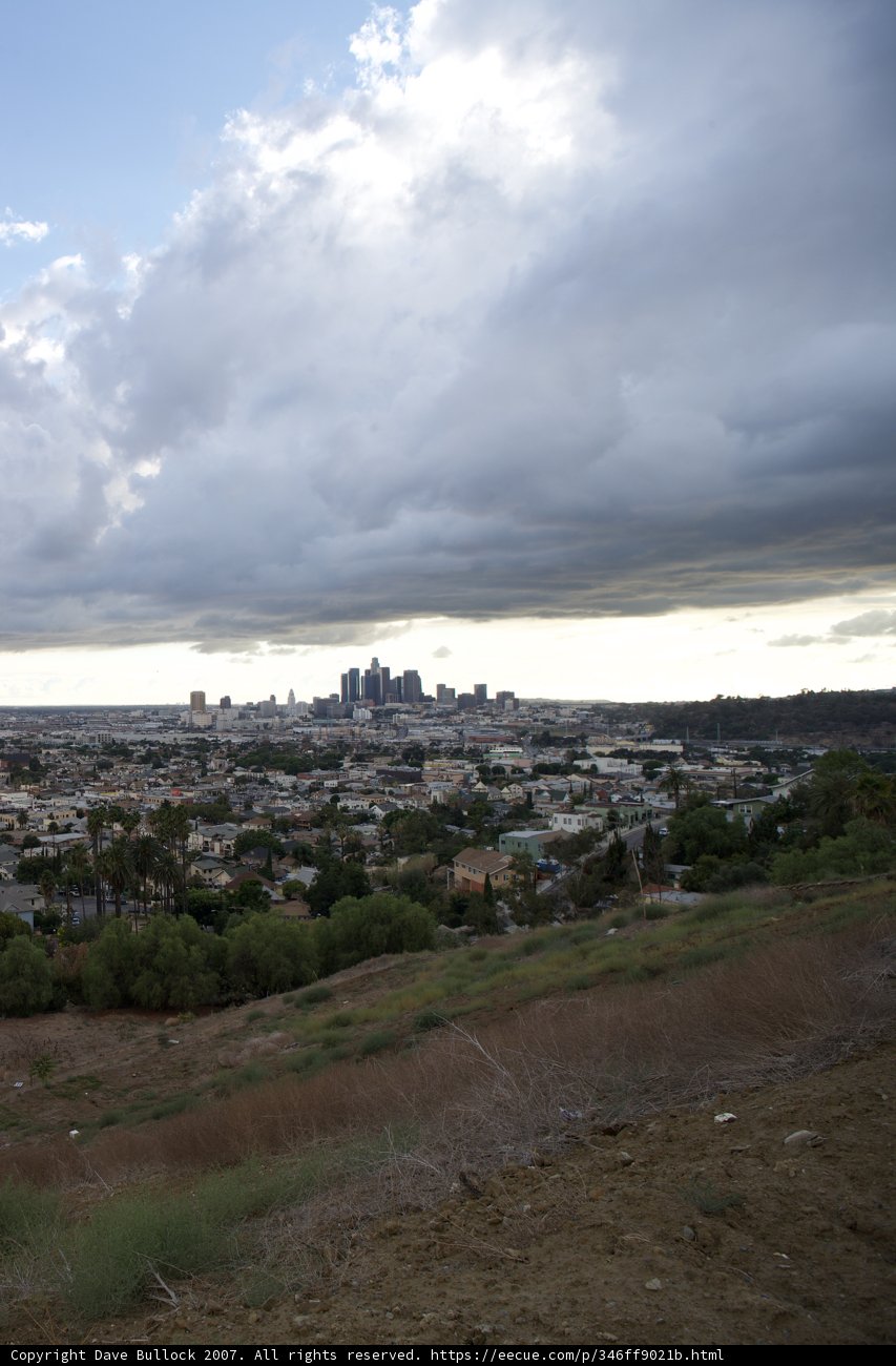 Majestic Cumulus Clouds Over Cityscape