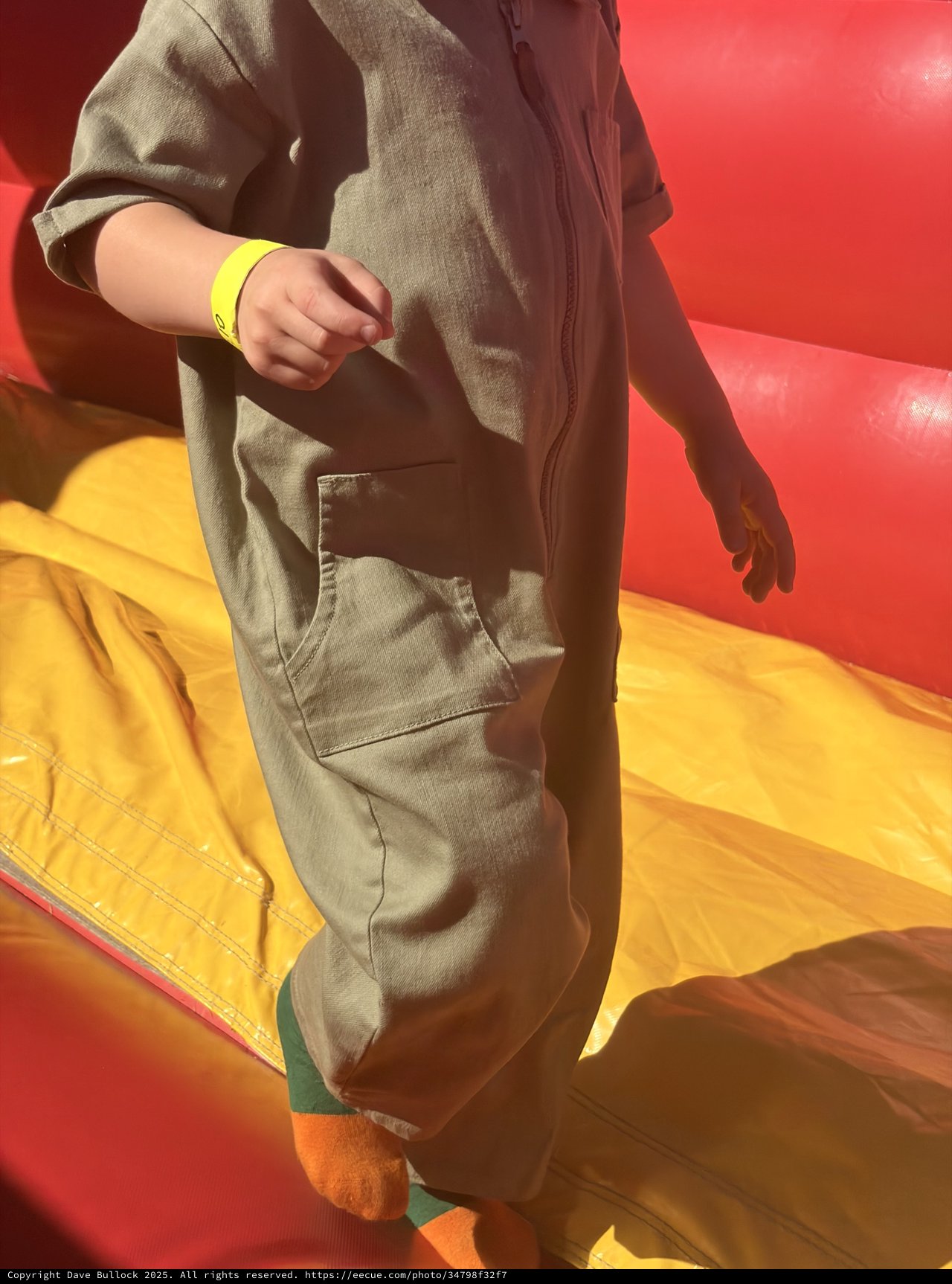 Child in Gray Hoodie on Colorful Playground Equipment
