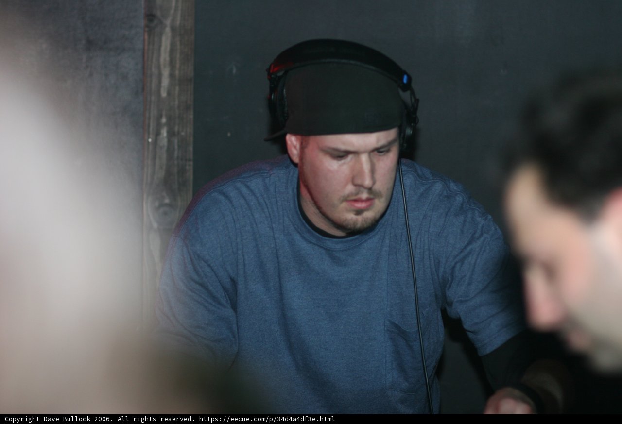 Headphone-wearing man in a stylish hat