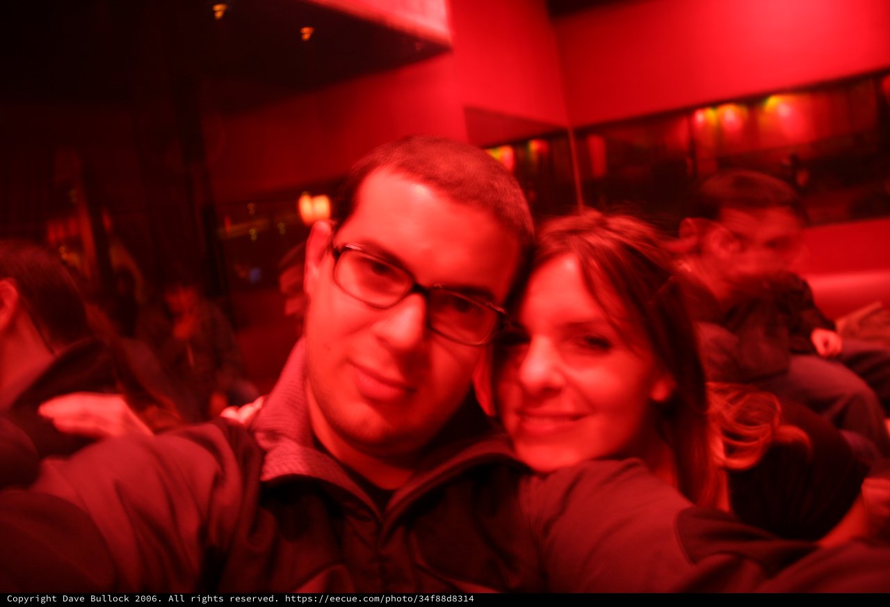 Couple Shares Intimate Moment in Red-Lit Bar
