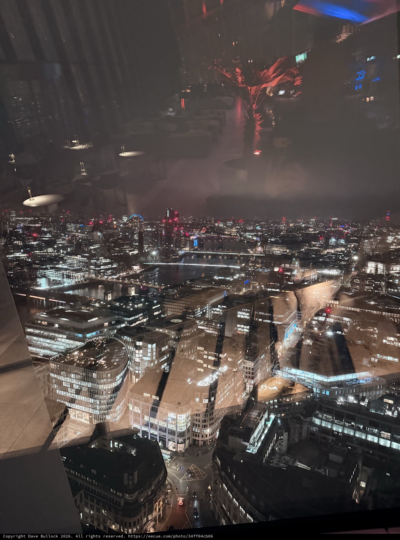 Reflective Night View Over London's Illuminated Cityscape