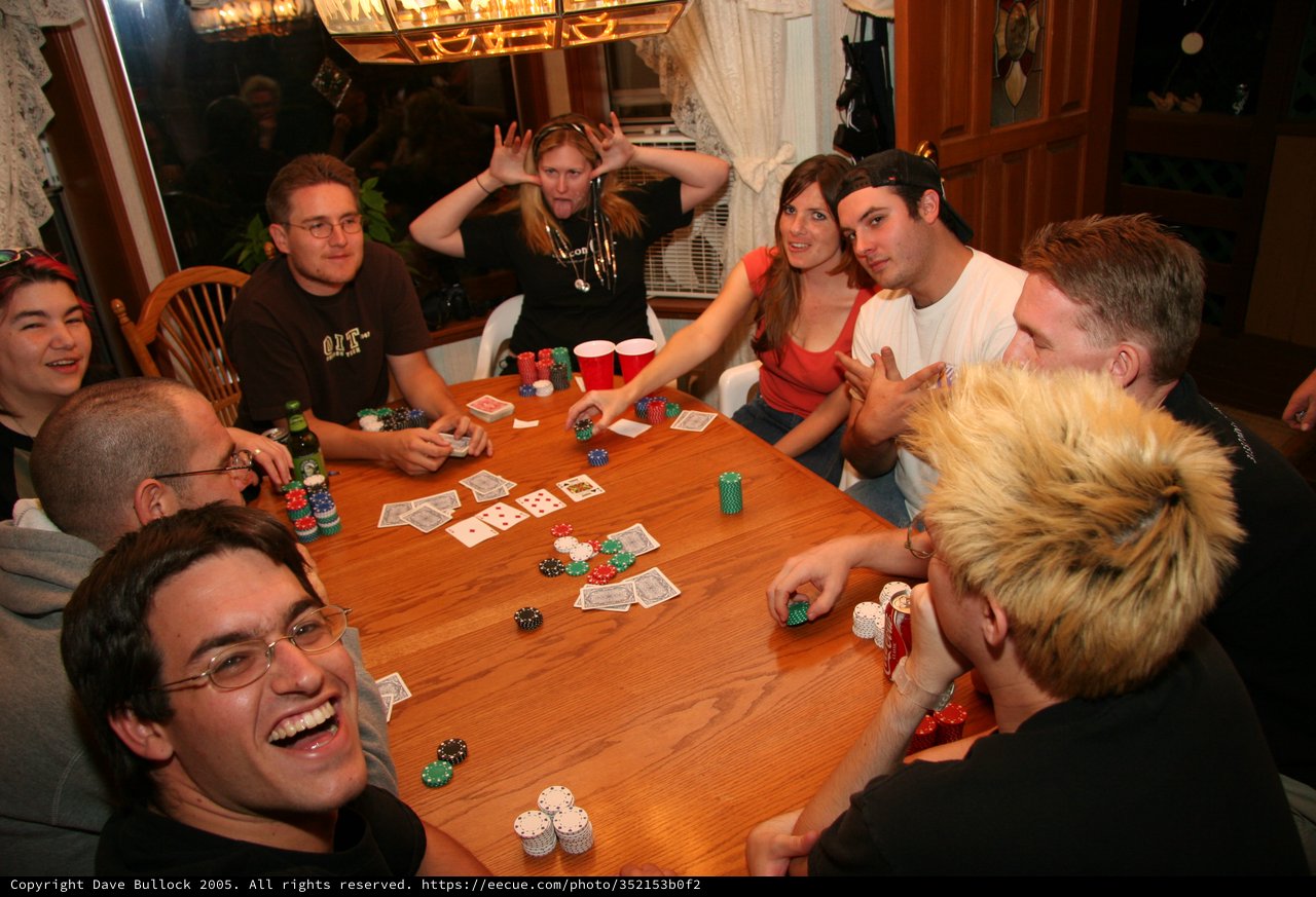 Friends Laughing Around Late-Night Poker Table