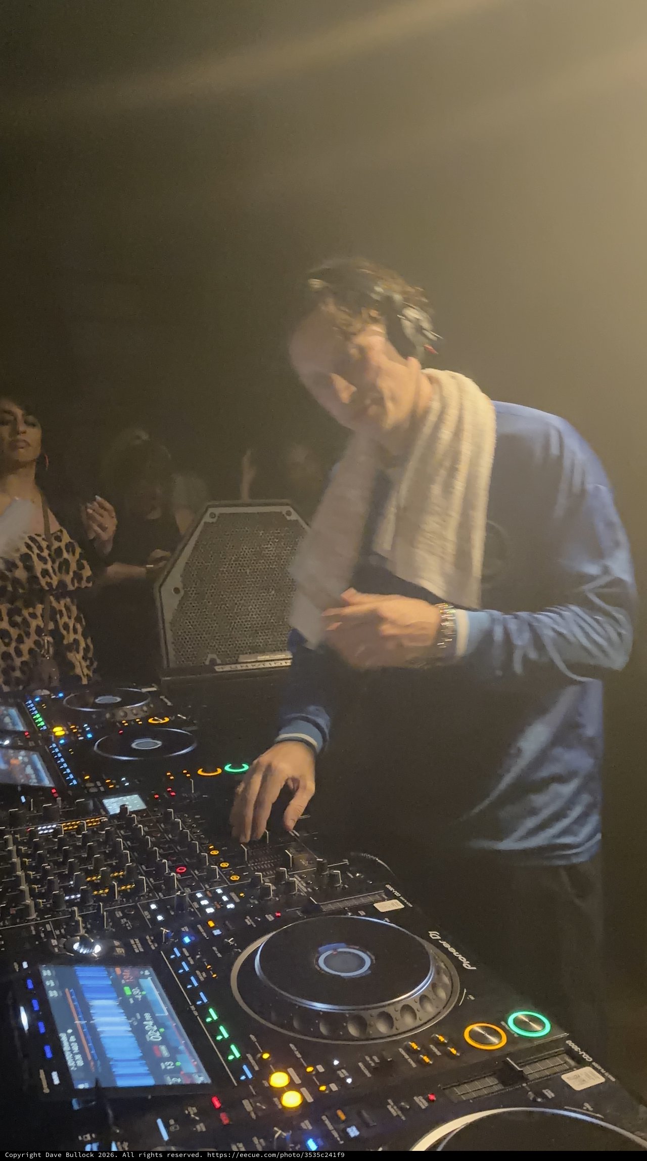 DJ Performance in Atmospheric Club Setting